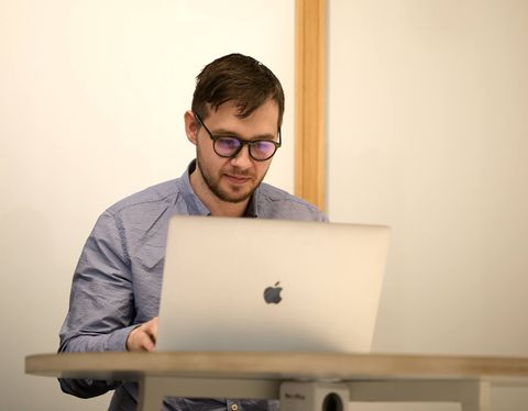 Man smiling at his laptop