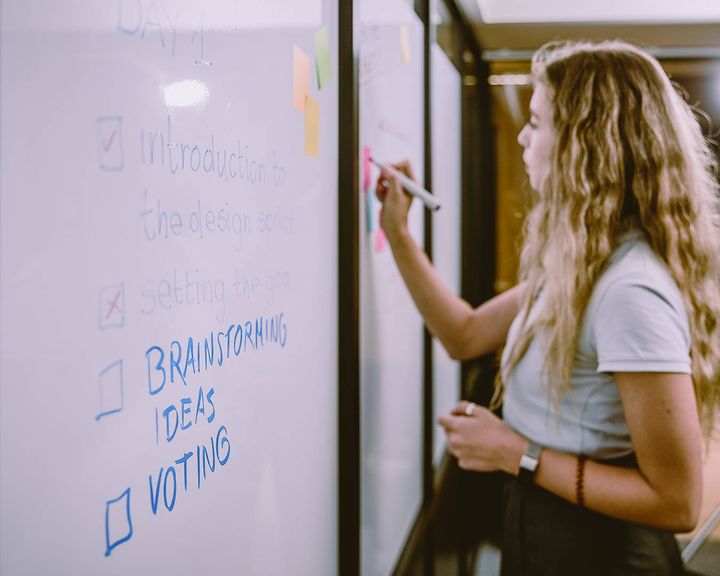 Woman writing on a whiteboard