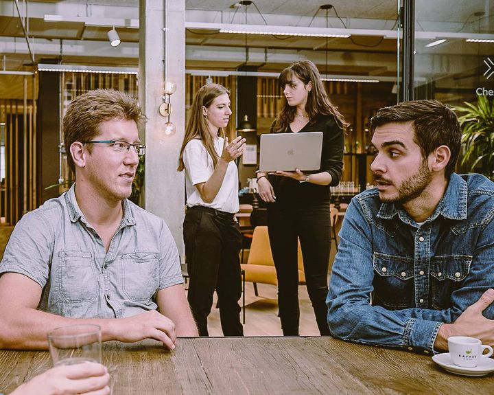 Two sets of people having a conversation