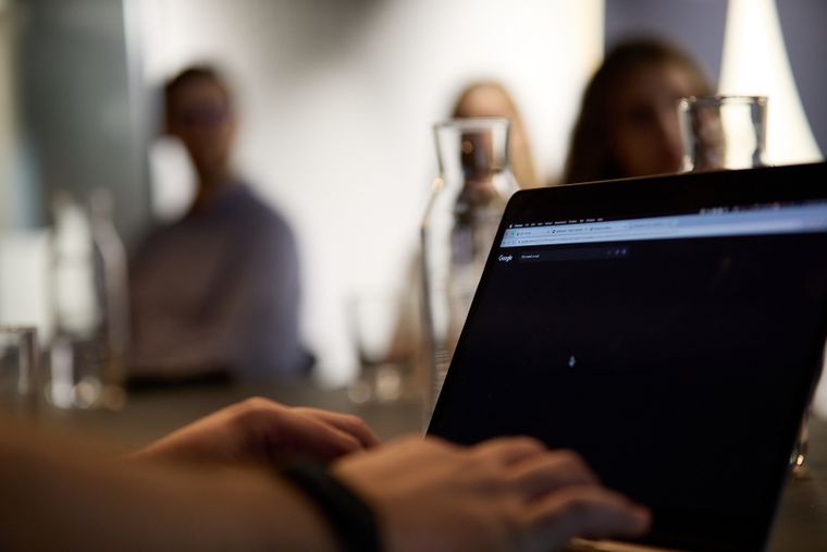 Close up of hands typing on a laptop